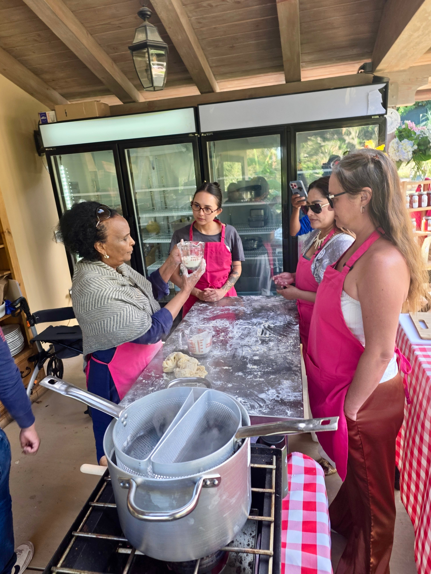 Cooking class with guests around the prep table