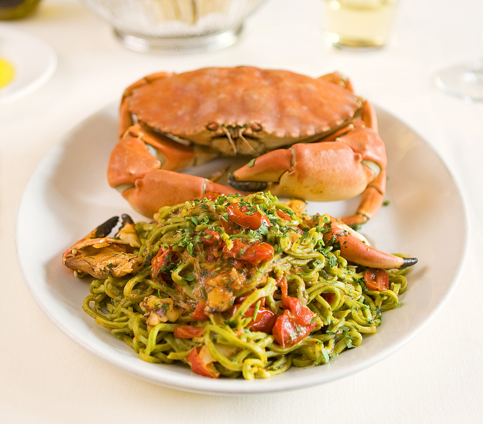 Hands holding three colored pasta sheets